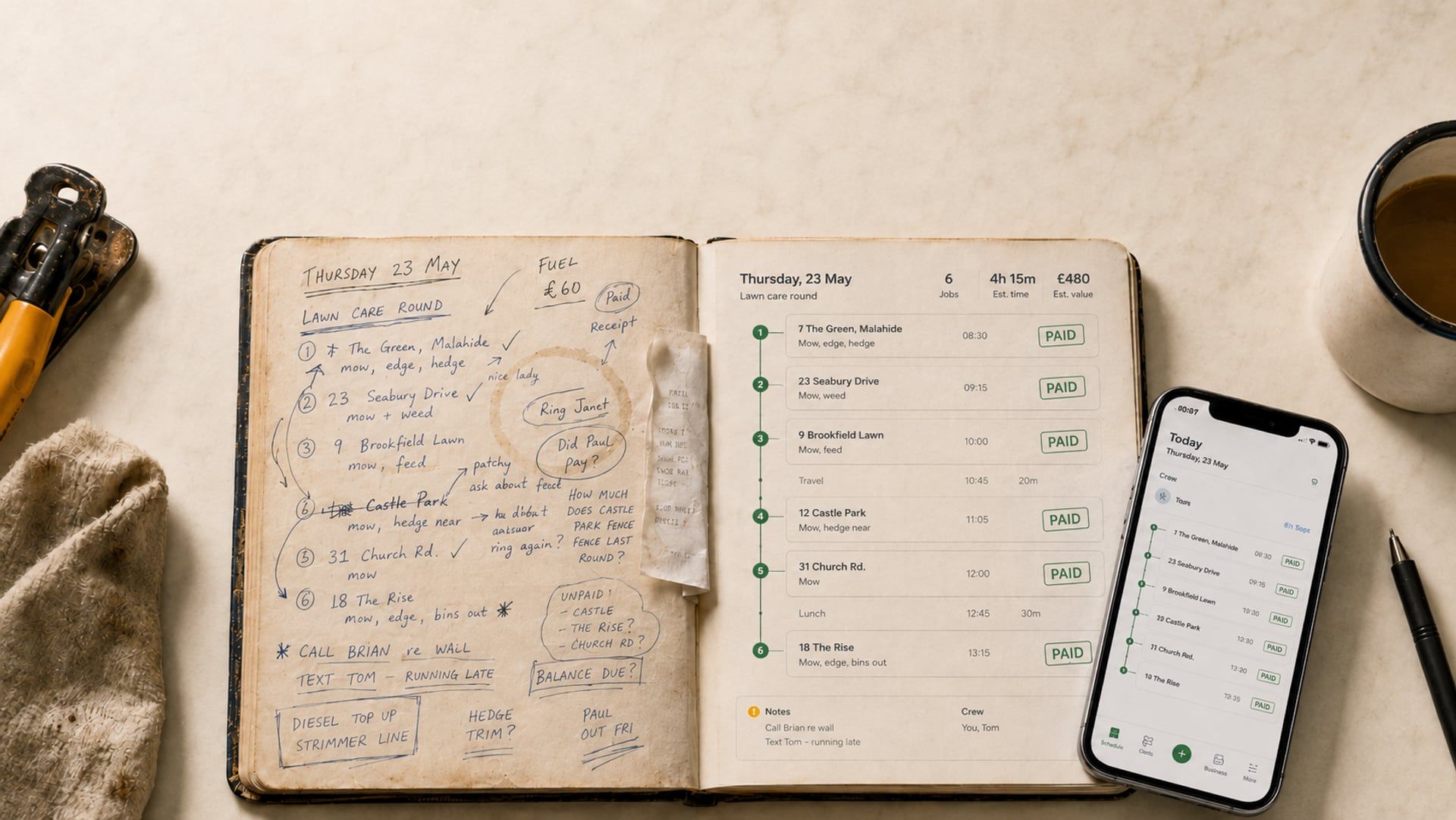 A worn work diary open on a kitchen table. The left page holds a handwritten lawn round with ticks and notes; the right page shows the same round as a clean app schedule with green PAID stamps, and the crew phone rests beside it.